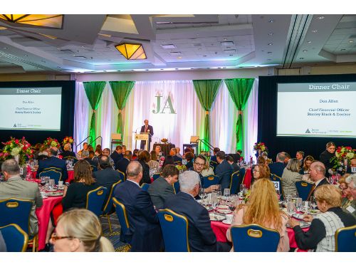 past event image of ballroom with people and stage