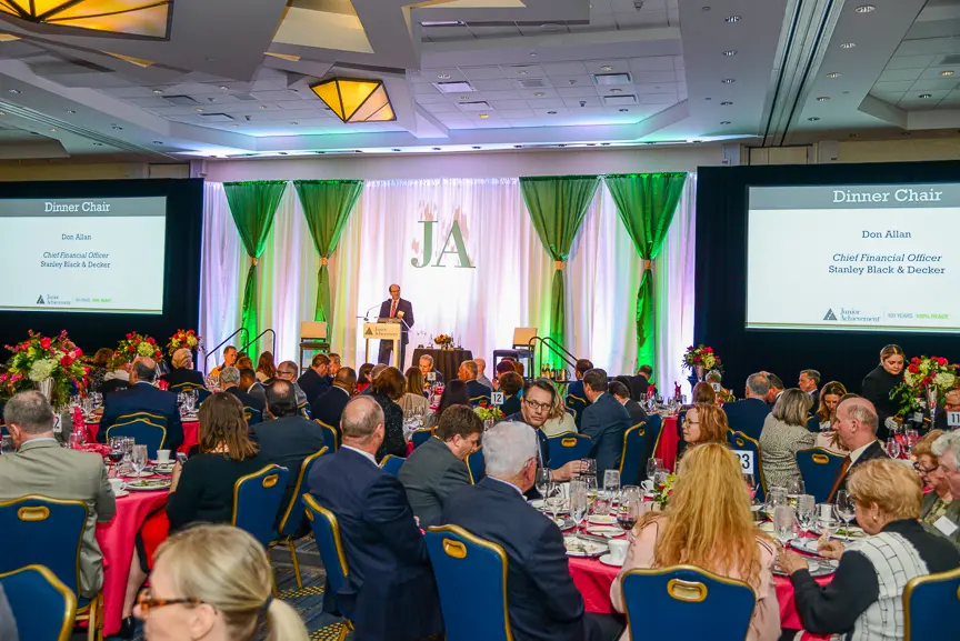 past event image of ballroom with people and stage