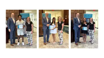 JA Scholarship recipients standing with their awards. From left to right: Stylz, Shesh, Hailey.