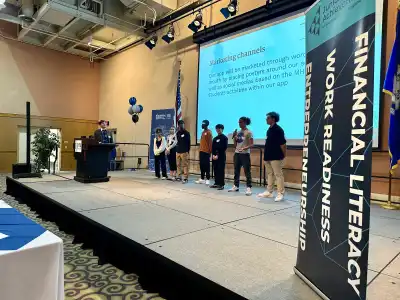 Student team presenting on stage at CCSU's Innovation Challenge