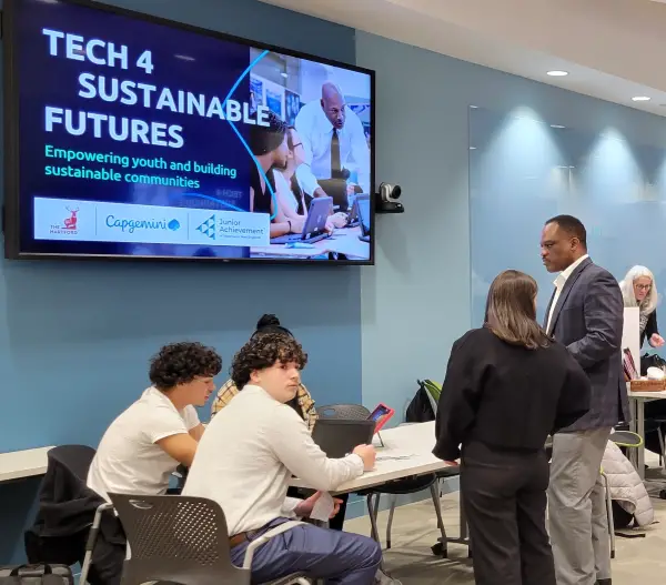 Action shot of students in business casual at Capgemini's Tech 4 Sustainable Futures Challenge