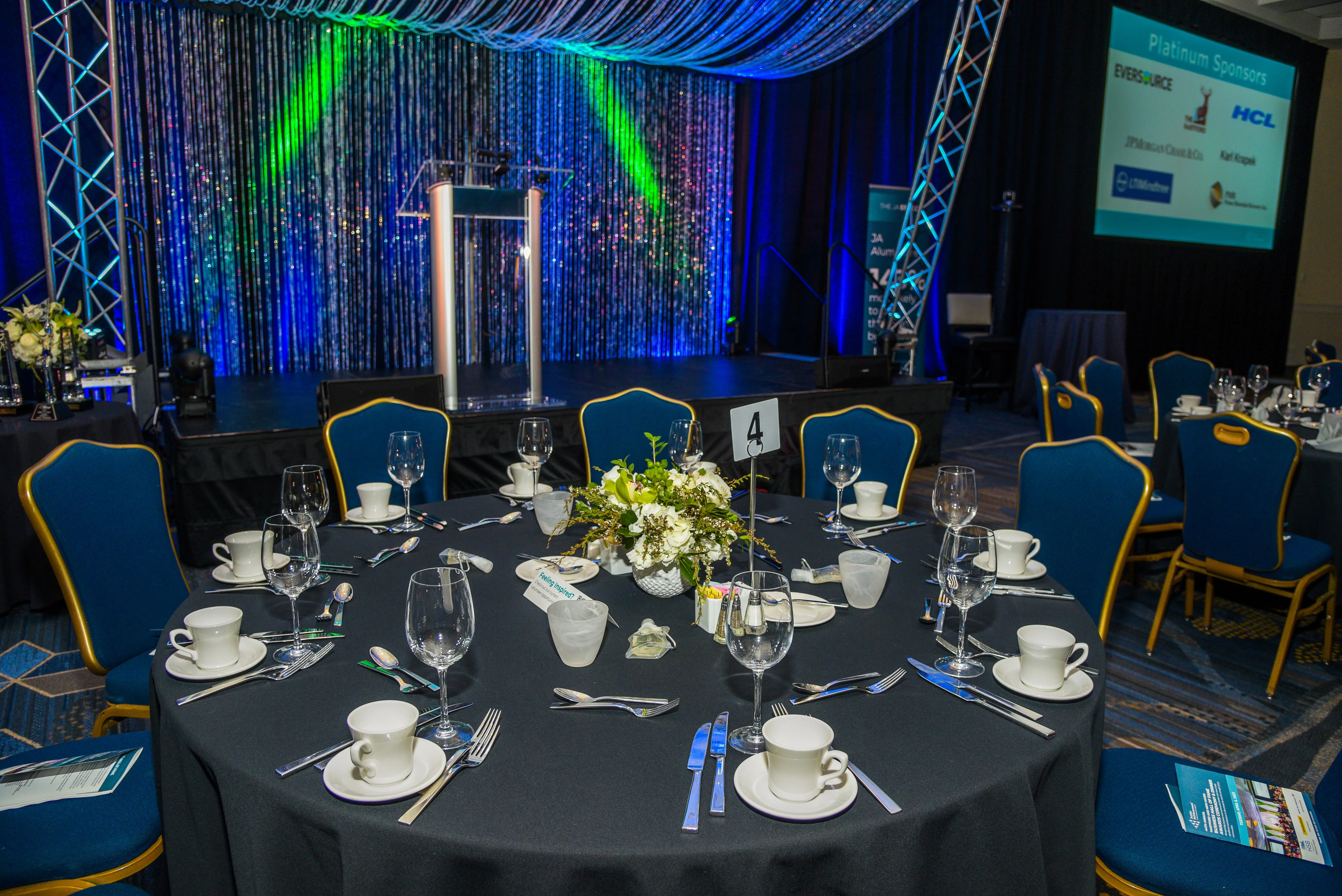 past event image of ballroom with people and stage